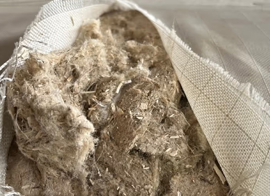 Mixed natural fibre materials stored in a bulk bag, showing varied textures and colours for product development